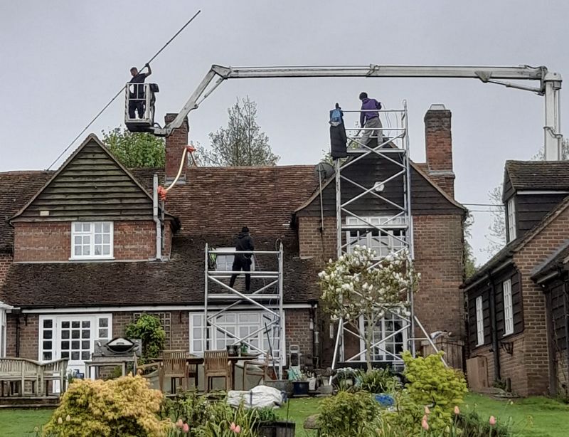 The Roof Moss Cleaners using cherry picker and scaffolding to clean roof safely and professionally in Woodley, Berkshire